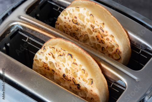 Photos Toasted crumpets cooked in an electric toaster appliance