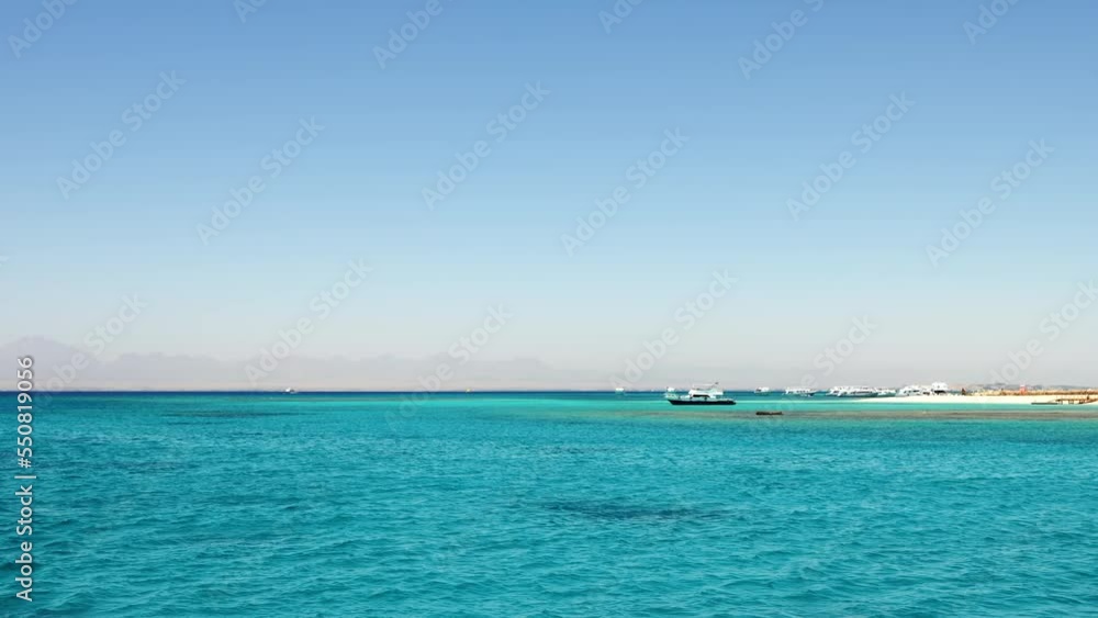 Orange Bay Beach in Hurghada, Egypt with crystal clear azure water and boat ships with tourists, 60 fps. Orange Bay Beach in Hurghada, Egypt with crystal clear azure water and boat ships with tourists, 60 fps.