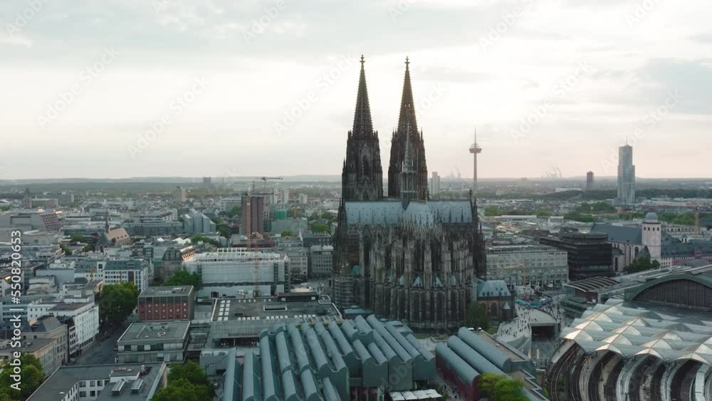 Drone moves epic towards the Cologne Cathedral, it comes very close to the Cologne Cathedral and you can see the sunbeams shining through the towers, cinematic intro Drone moves epic towards the Cologne Cathedral, it comes very close to the Cologne Cathedral and you can see the sunbeams shining through the towers, cinematic intro