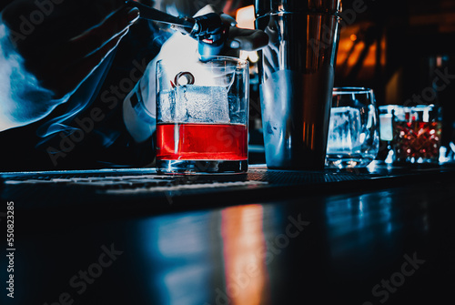 woman bartender making cocktail in bar