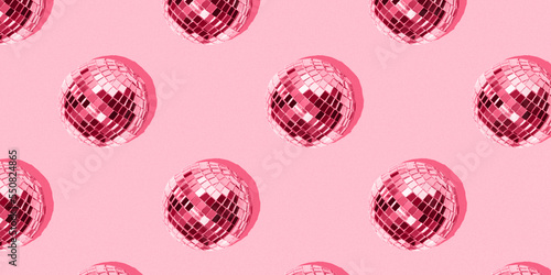 Seamless pattern with mirrored disco balls on a pink background. Image toned in the color of the year 2023
