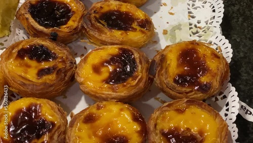 Famous Custard Tart In Portugal, Panning Shot. Pastel de nata is an egg tart pastry very common in Portugal photo