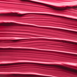 Aesthetic texture of red magenta liquid cosmetic lipstick. Demonstration red magenta color of 2023 Viva Magenta in makeup and cosmetic. Abstract background brush strokes of red magenta tinted cream