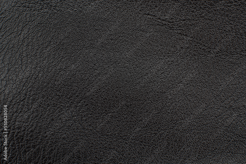 Black leather texture. Abstract background of dark leather with small roughness and scuffs Black leather texture. Abstract background of dark leather with small roughness and scuffs