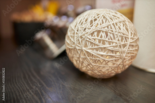 a decorative ball of white thread and glue lies on the table