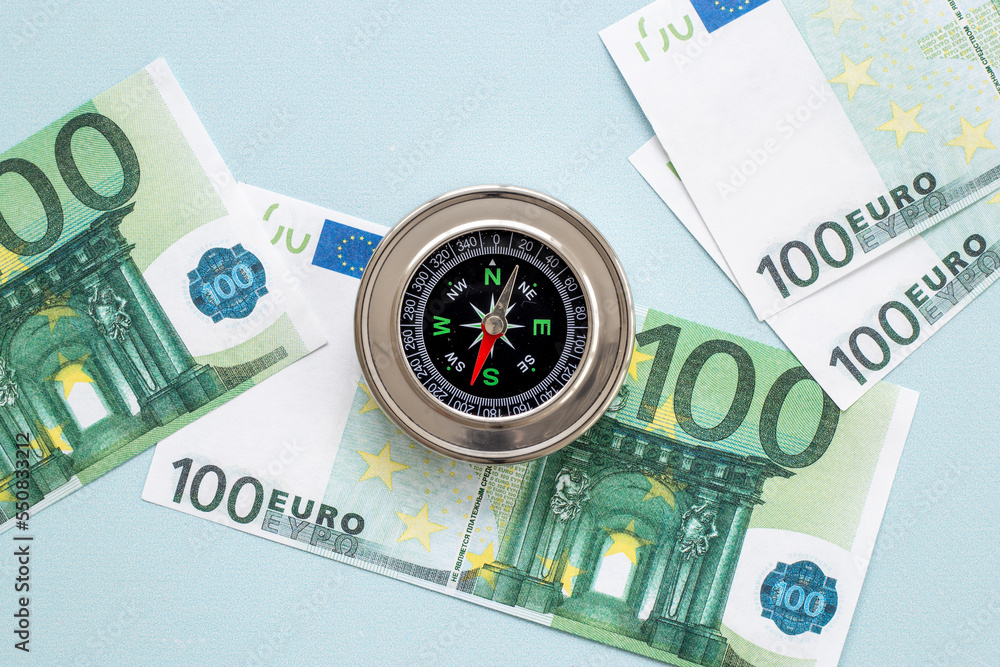 Compass and money cash. Exchange quotes of currencies concept Compass and money cash. Exchange quotes of currencies concept
