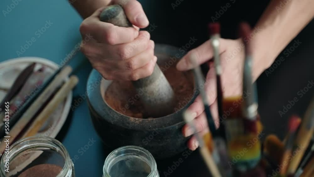 Сlose-Up Of A Stone Mortar And Pestle grinding red sand red clay Сlose-Up Of A Stone Mortar And Pestle grinding red sand red clay