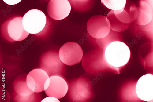 Viva magenta blurred lights abstract background. Christmas holiday defocused bokeh