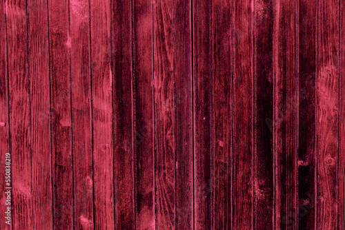 Old distressed magenta wood texture background.