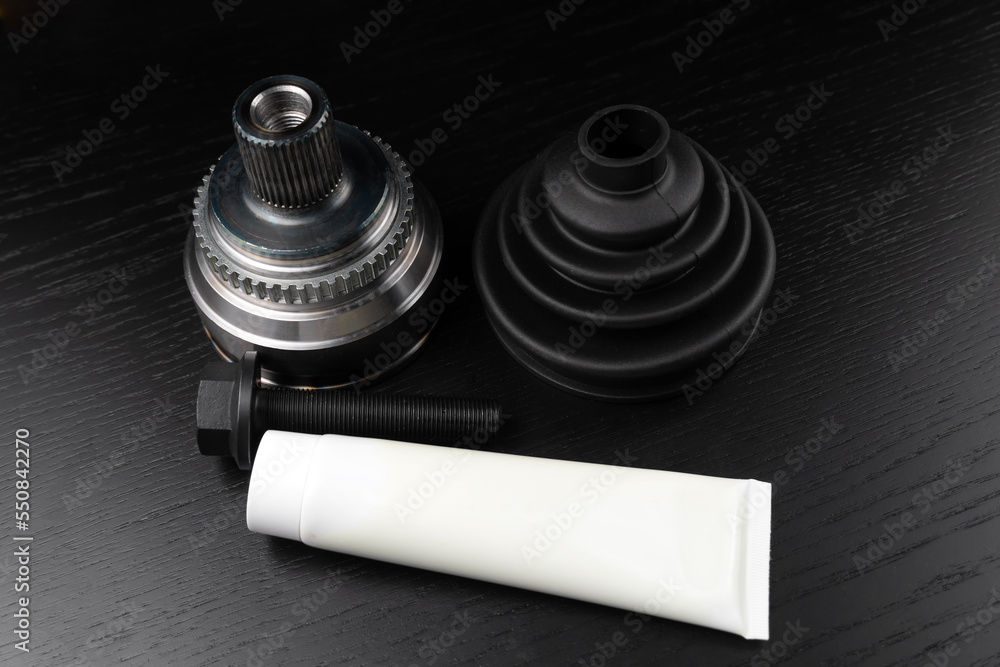 Car CV joint. Drive shaft connection on black background. New constant