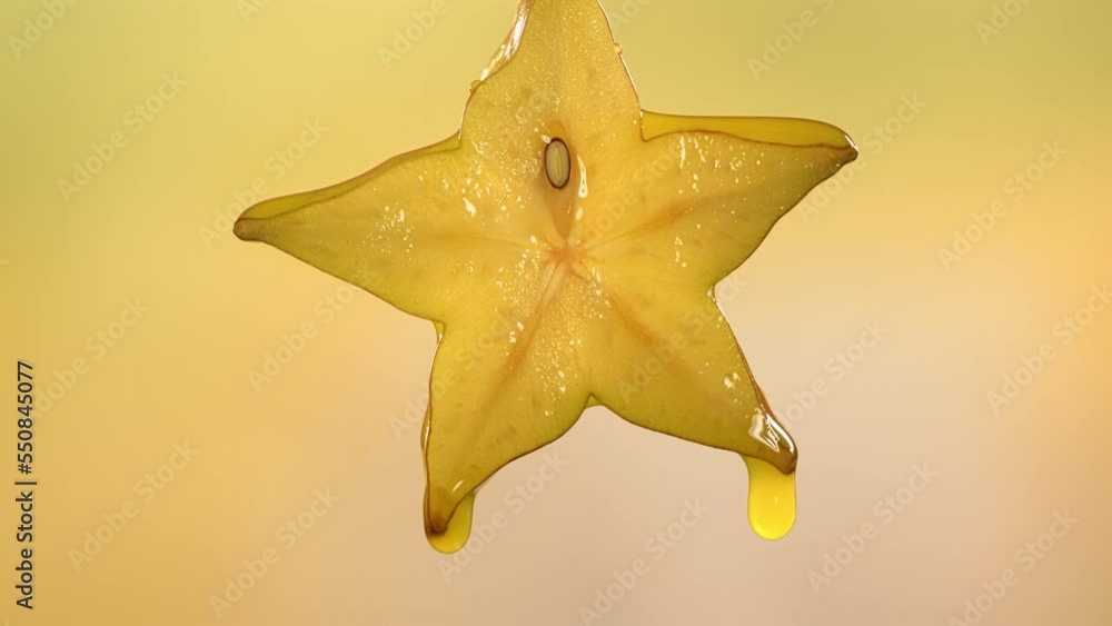 Slow Motion Macro Shot of Flowing Carambola Juice from Halved Carambola Star Fruit Slow Motion Macro Shot of Flowing Carambola Juice from Halved Carambola Star Fruit