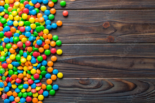 Mixed collection of colorful candy, on colored background. Flat lay, top view. frame of colorful chocolate coated candy