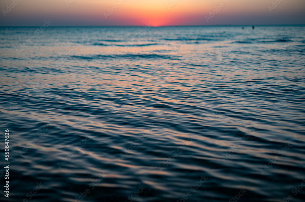 Close up of sea surface on sunset. Water background Close up of sea surface on sunset. Water background