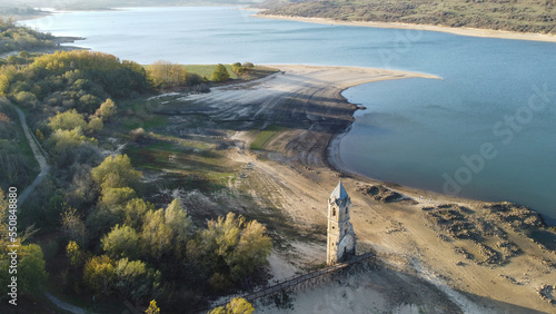 Torre de la iglesia de Villanueva de Las Rozas, al atardecer, sin agua junto al Pantano del Ebro photo