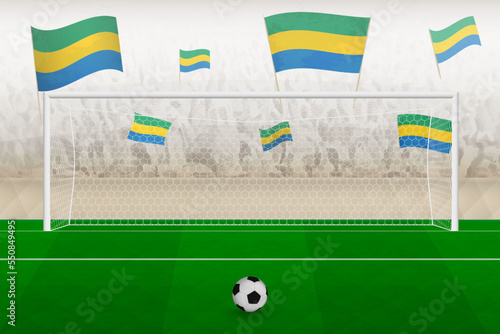 Gabon football team fans with flags of Gabon cheering on stadium, penalty kick concept in a soccer match.