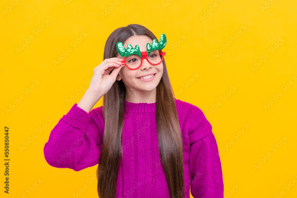 cheerful child in party glasses on yellow background, xmas cheerful child in party glasses on yellow background, xmas