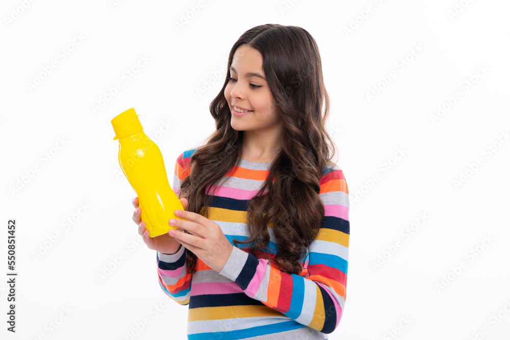 Teen holds water bottle isoalted on white. Child girl care body hydration. Active leisure and water balance. Active and healthy kid drink water. Happy girl face, positive and smiling emotions. Teen holds water bottle isoalted on white. Child girl care body hydration. Active leisure and water balance. Active and healthy kid drink water. Happy girl face, positive and smiling emotions.