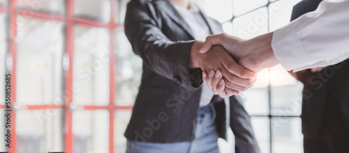 Business handshake for teamwork of business merger and acquisition,successful negotiate,hand shake,two businessman shake hand with partner to celebration partnership and business deal concept 