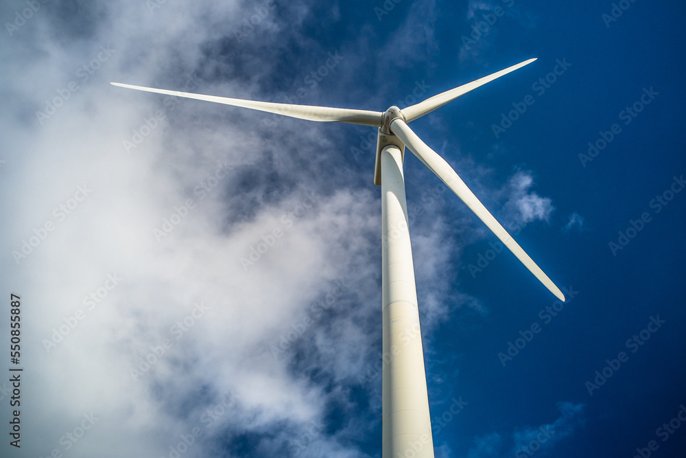 wind turbine close-up view from below against blue sky. Wind power plant. Renewable energy wind turbine close-up view from below against blue sky. Wind power plant. Renewable energy