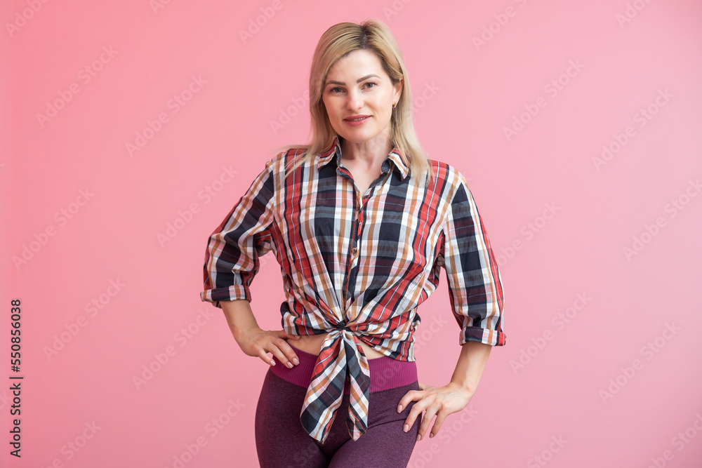 woman with long blonde hair standing isolated over pink background, posing woman with long blonde hair standing isolated over pink background, posing