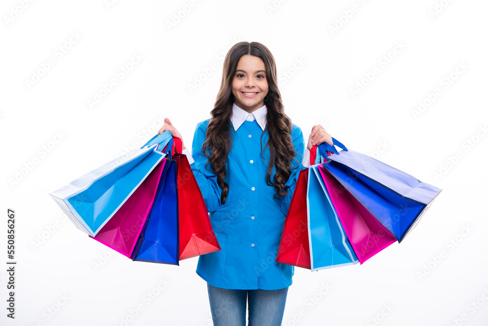 Sale and shopping concept. Teen girl holding shopping bags, isolated on studio background.