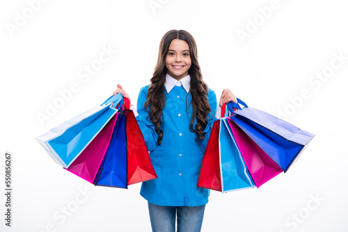 Sale and shopping concept. Teen girl holding shopping bags, isolated on studio background.