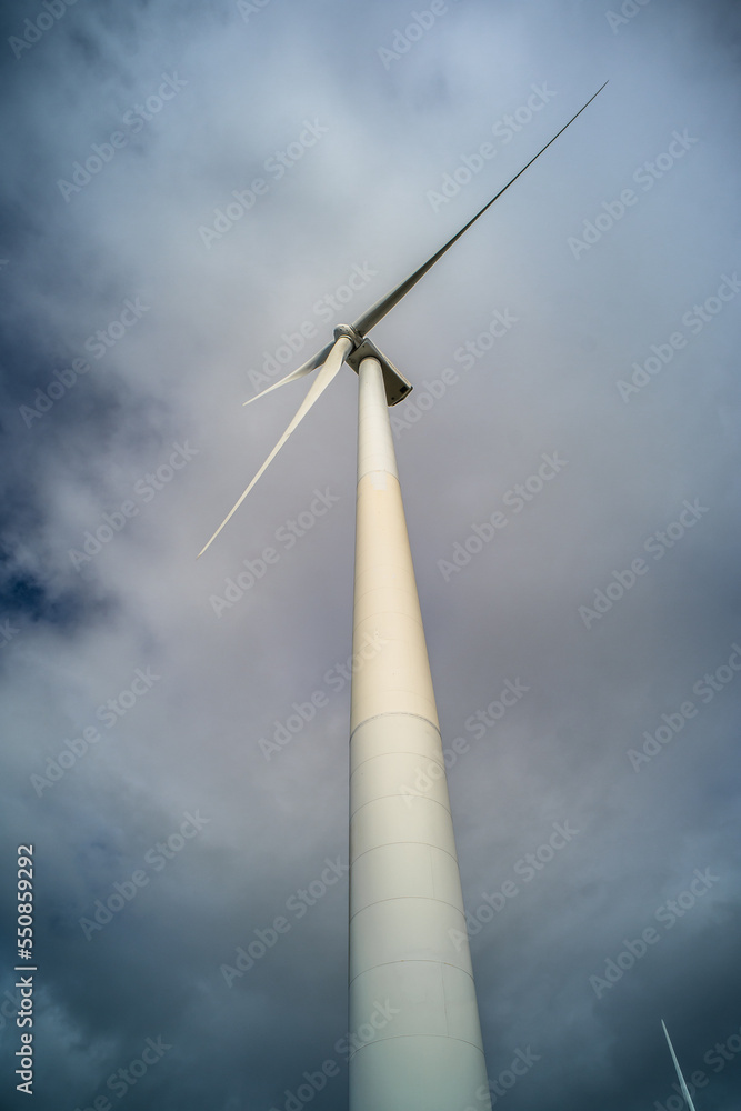 Wind turbines against the cloudy sky. Wind power plant Wind turbines against the cloudy sky. Wind power plant