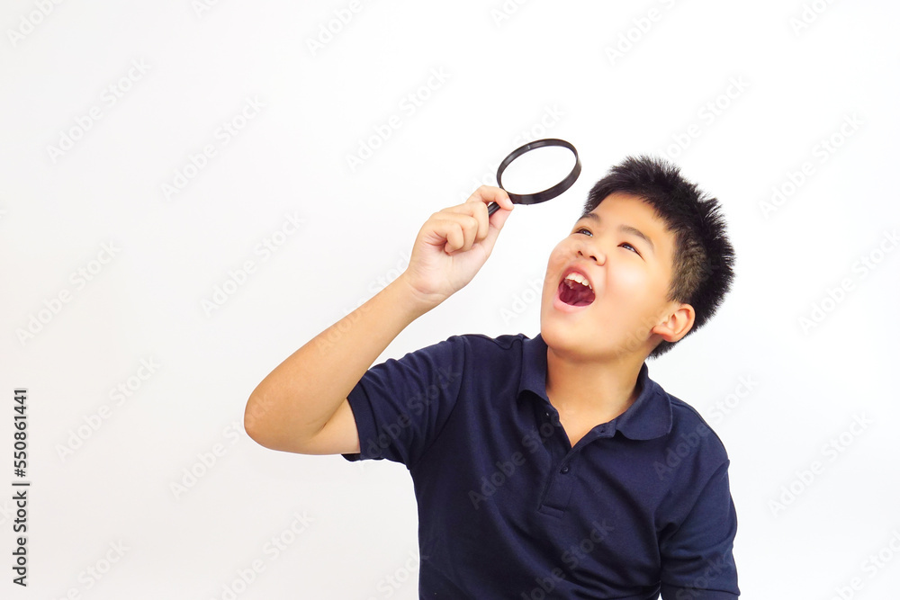 Boy holding a magnifying glass on white background. Knowledge, research and explore concept. Boy holding a magnifying glass on white background. Knowledge, research and explore concept.