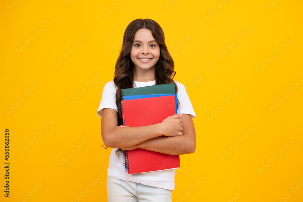 Schoolgirl with copy book posing on isolated background. Literature lesson, grammar school. Intellectual child reader. Schoolgirl with copy book posing on isolated background. Literature lesson, grammar school. Intellectual child reader.