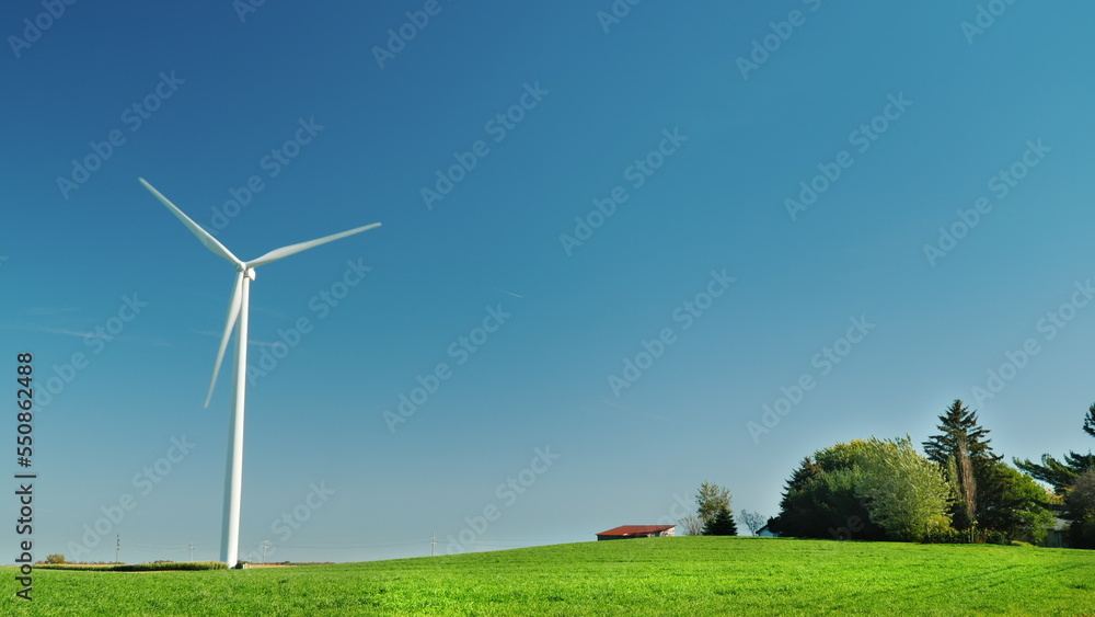 Idyllicistic landscape of a green meadow and a wind generator. Ecology and environment concept. Idyllicistic landscape of a green meadow and a wind generator. Ecology and environment concept.