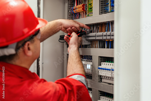 Electrical wiring repair. Repairman repairs electrical panel.