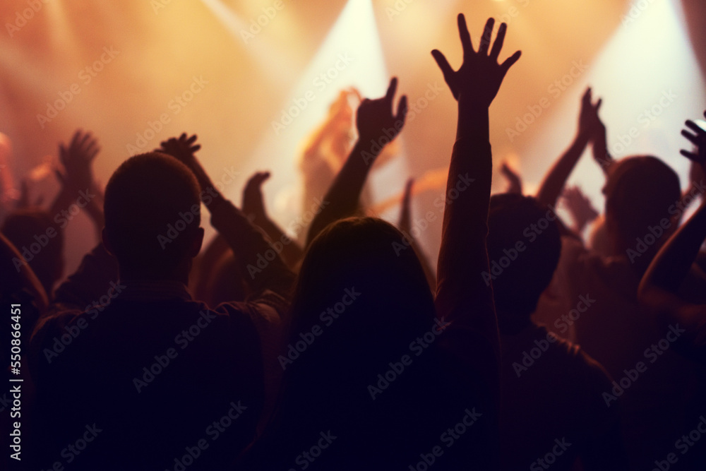 Music, lights and hands of crowd at concert for party, disco and live band performance. Dance, nightclub and silhouette of audience listening to artist on stage at festival for energy, rave and event Music, lights and hands of crowd at concert for party, disco and live band performance. Dance, nightclub and silhouette of audience listening to artist on stage at festival for energy, rave and event