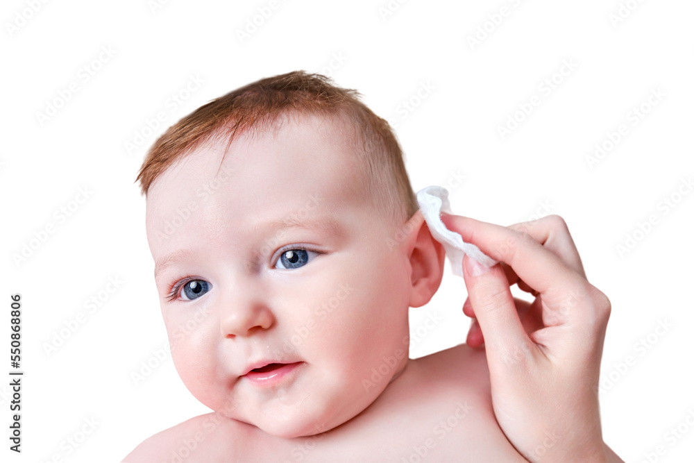 Mother hands wash the ears of a happy infant baby with a cotton pad, isolated on a white background. Mom holds hygiene face toddler kid on the sofa, six to seven months old Mother hands wash the ears of a happy infant baby with a cotton pad, isolated on a white background. Mom holds hygiene face toddler kid on the sofa, six to seven months old