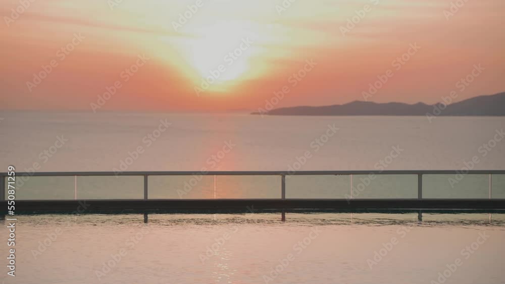Beautiful sunset in the sea, view from swimming a pool Beautiful sunset in the sea, view from swimming a pool