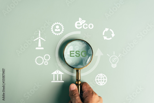 ESG Environmental, environmental, social, and governance in sustainable and ethical business on the Network connection, Magnifier focus to Earth ESG icon for develop green energy concept.