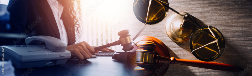 Business and lawyers discussing contract papers with brass scale on desk in office. Law, legal services, advice, justice and law concept picture with film grain effect Business and lawyers discussing contract papers with brass scale on desk in office. Law, legal services, advice, justice and law concept picture with film grain effect