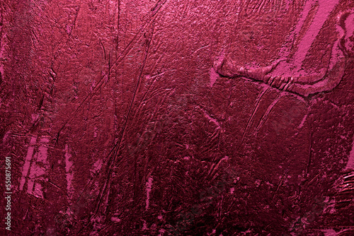 Textured magenta stucco background with scratches,