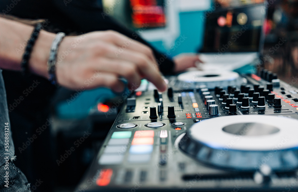 DJ Hands creating and regulating music on dj console mixer in concert DJ Hands creating and regulating music on dj console mixer in concert