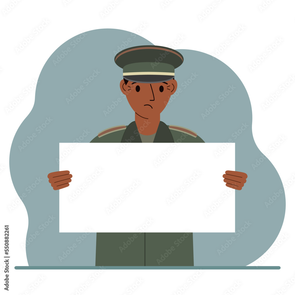 A military man in uniform holds a white sheet of paper in his hands. Concept for advertising, poster, banner. A military man in uniform holds a white sheet of paper in his hands. Concept for advertising, poster, banner.