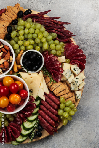 An abundant charcuterie board, rich with assorted meats, cheeses, and fresh fruits, perfect for a luxurious gathering