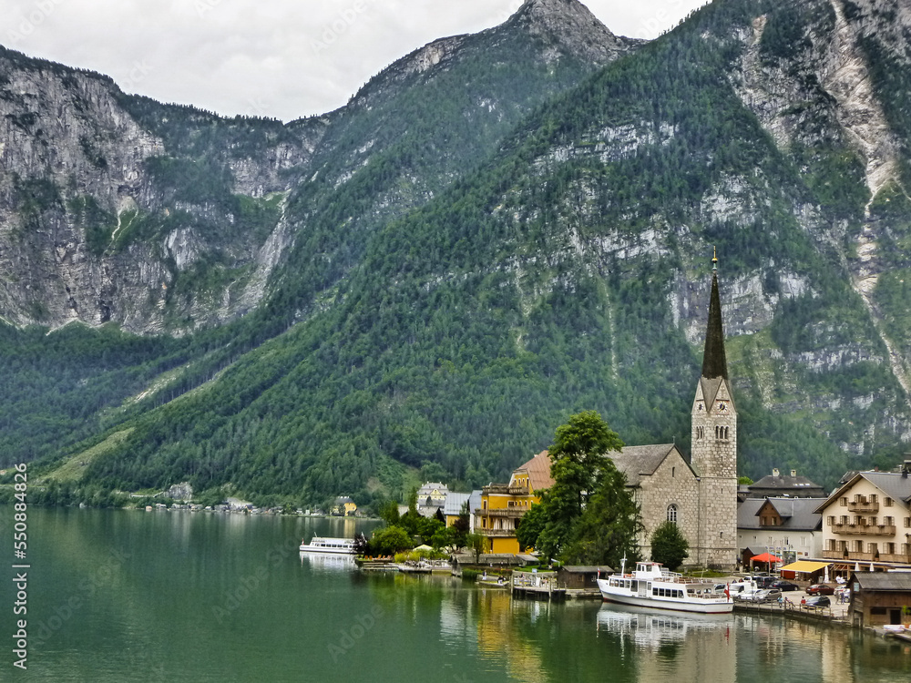 Scenic postcard view of famous Hallstatt mountain village in Austrian Alps, Salzkammergut region, Hallstatt, Austria Scenic postcard view of famous Hallstatt mountain village in Austrian Alps, Salzkammergut region, Hallstatt, Austria