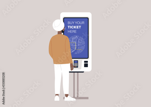 A young indian sikh man using a self-service ticket machine, a daily commute concept, urban transportation system