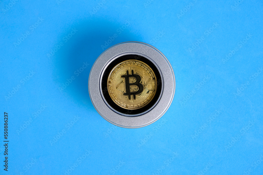Gold bitcoin coin in gift box blue background. Gold bitcoin coin in gift box blue background.