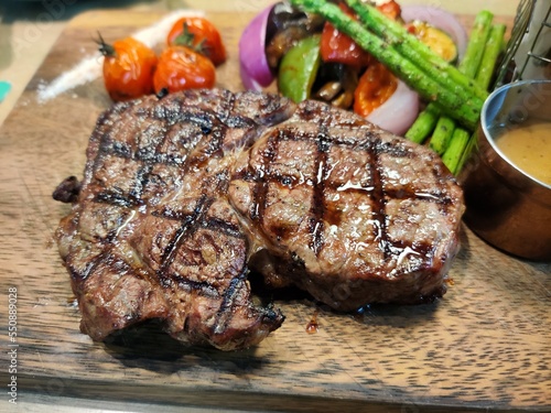 Medium roast beef steak set macro highlight steak in health food restaurant, Medium cooked steak on a wooden chopping board, Close up on beef steak.