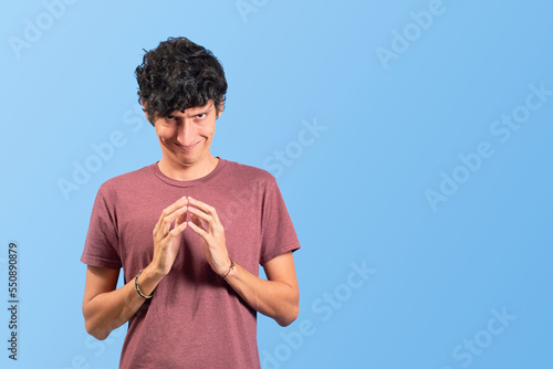Canvas Print Young man with evil and funny face on flat lay.