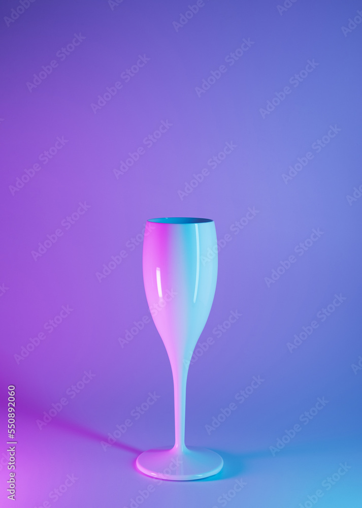 Celebration, New Year futuristic concept. Champagne glass with neon illumination. Cyberpunk, artificial space.