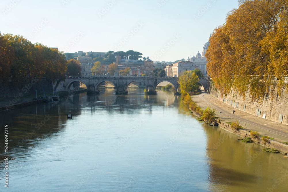 Tiber River near Prati district in Rome, Italy. Autumn colors dye the trees along the river.