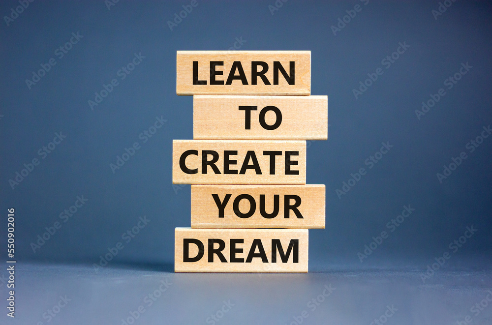 Create your dream symbol. Concept words Learn to create your dream on wooden blocks. Beautiful grey table grey background. Business learn to create your dream concept. Copy space.