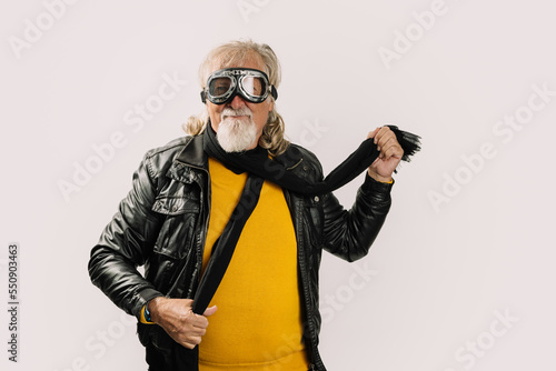 Positive senior rocker in glasses on white background photo