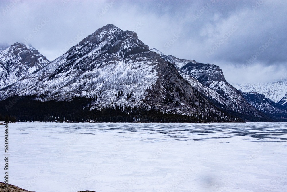 Fototapeta premium Ice is still frozen on Lake Minewnaka. Banff National Park, Alberta, Canada